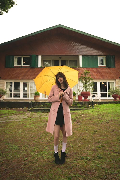 Woman Holding Yellow Umbrella