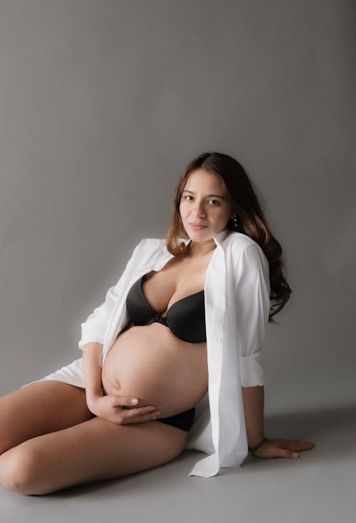 A Pregnant Woman in a White Shirt