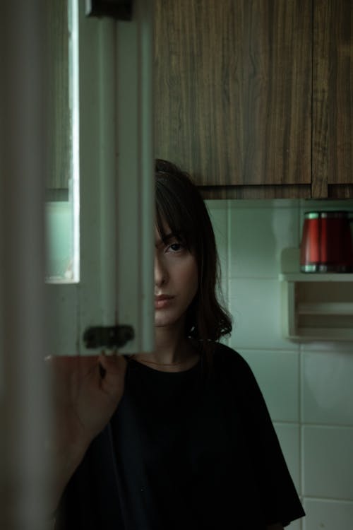 Woman Standing While Wearing Black Shirt Inside Kitchen