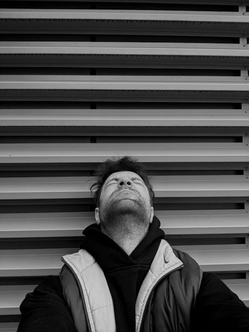 A man laying down on the ground with his head in the air