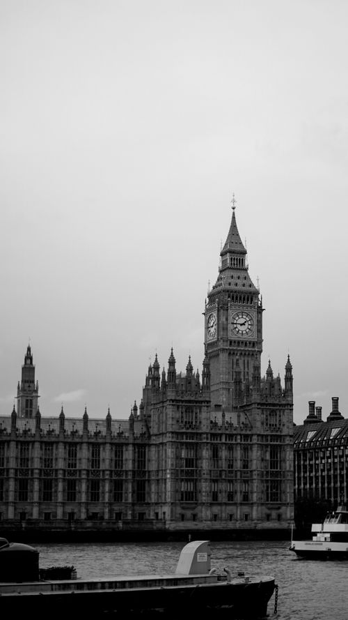 Free Dramatic black and white view of London's Big Ben and Thames River. Stock Photo
