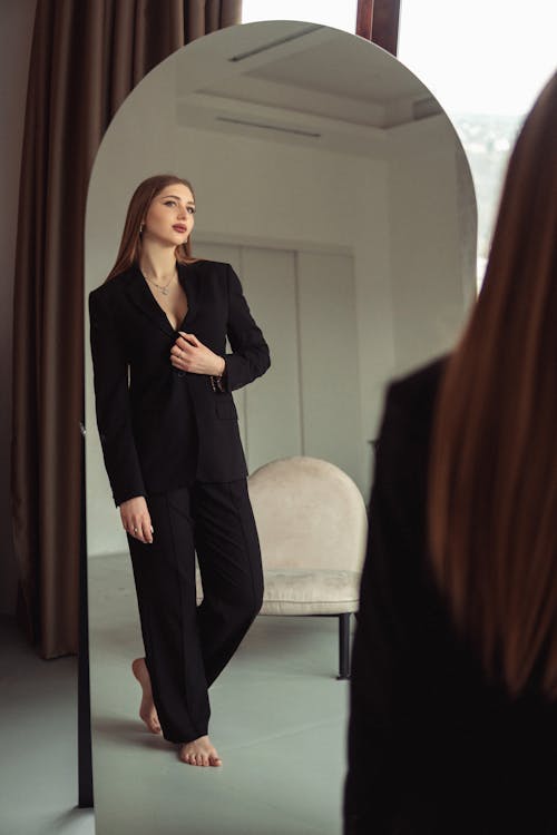 Woman in Black Suit Reflection in Mirror