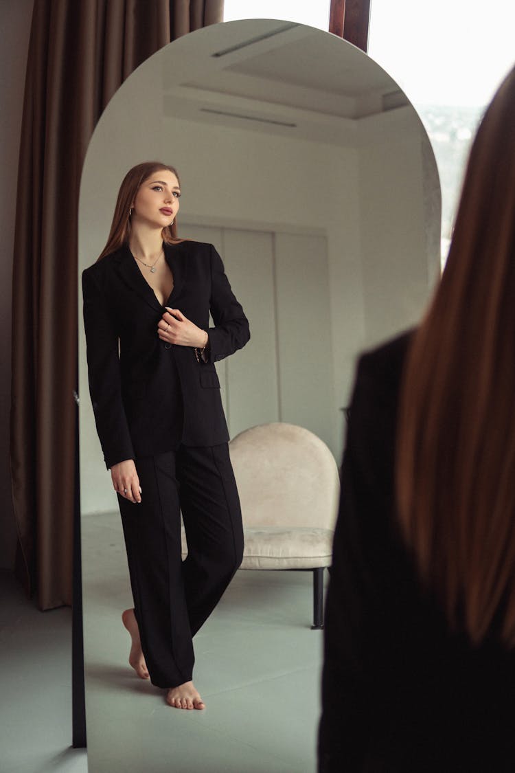 Woman In Black Suit Reflection In Mirror