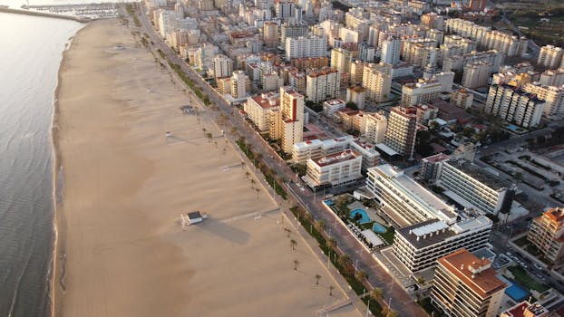 A stunning aerial view of Gandia's cityscape and beach, capturing urban modernity and natural beauty.