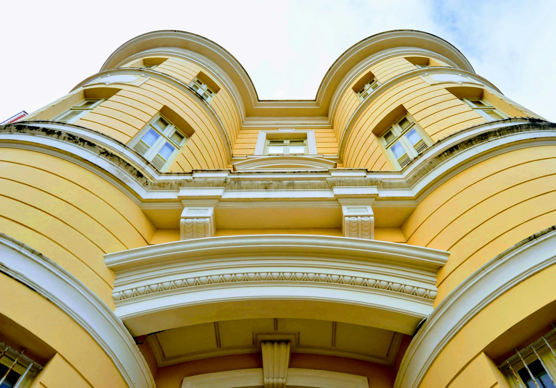 Captivating low angle shot of a historic yellow building in Recife, showcasing beautiful architectural details.