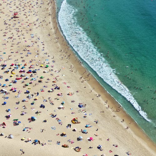 An aerial view of a crowded beach with people
