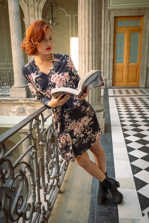 Free Redhead Woman Standing with Book Stock Photo