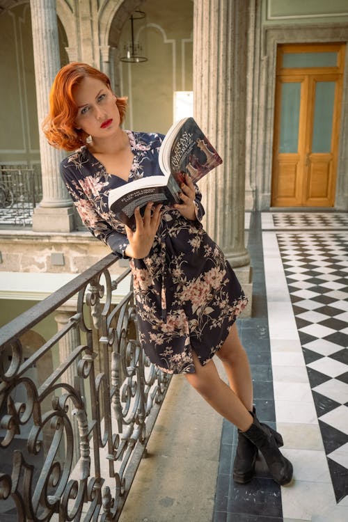 Free Redhead Woman Standing with Book Stock Photo