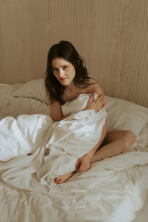 Nude Woman Cover her Body with Bedding