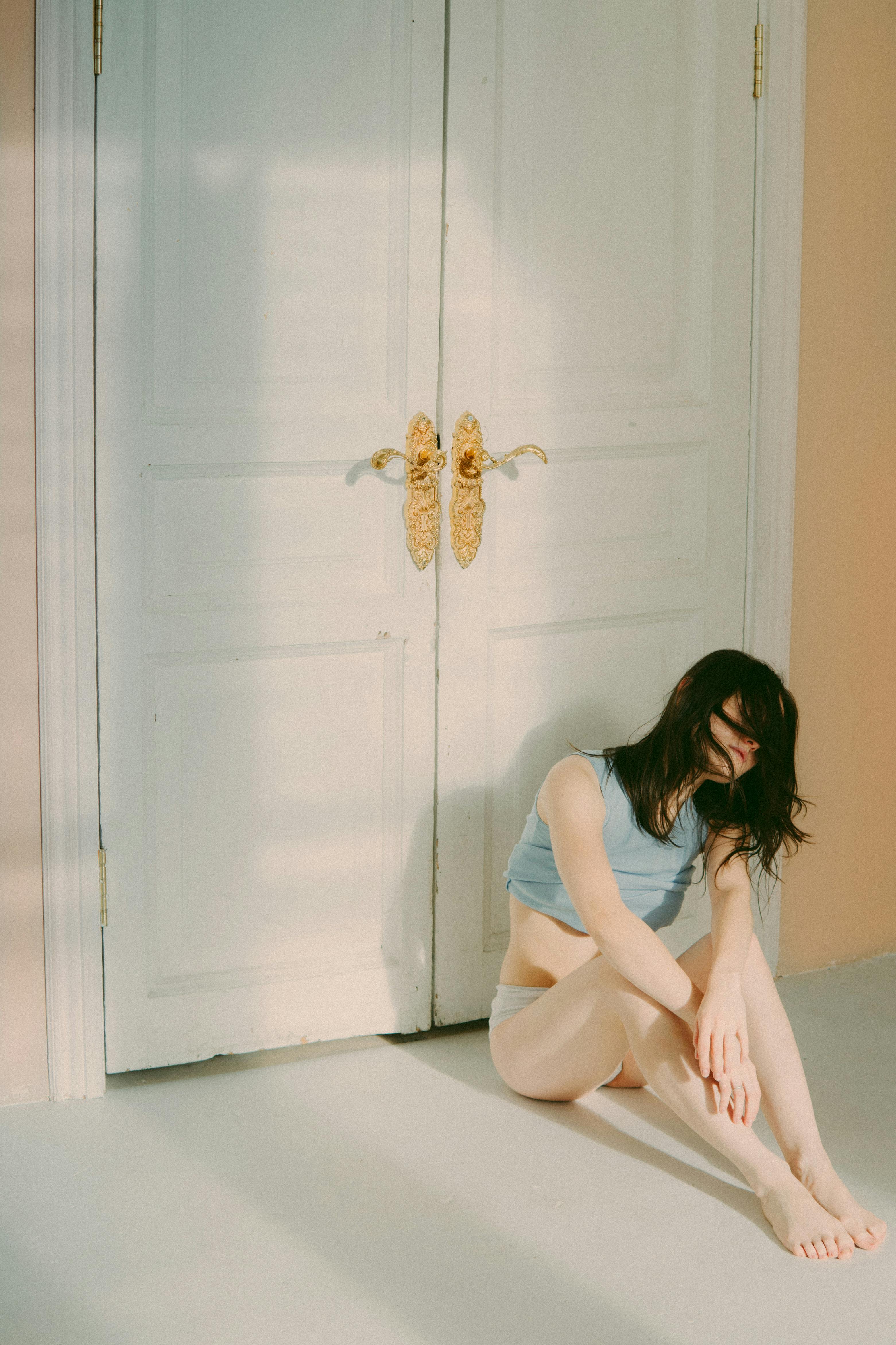 woman sitting in front of a door