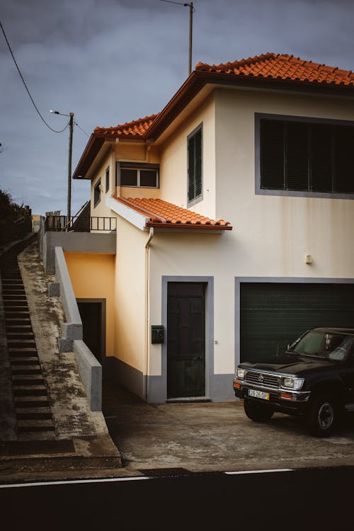 A car parked in front of a house with stairs
