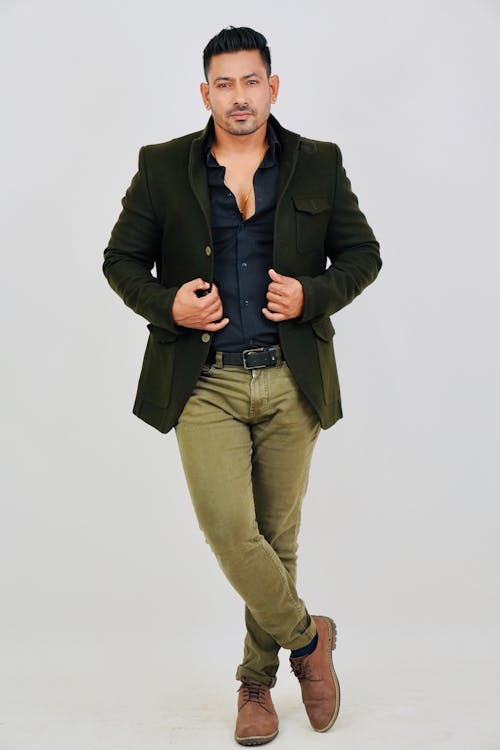 Handsome Man in Dark Green Jacket Posing in Studio