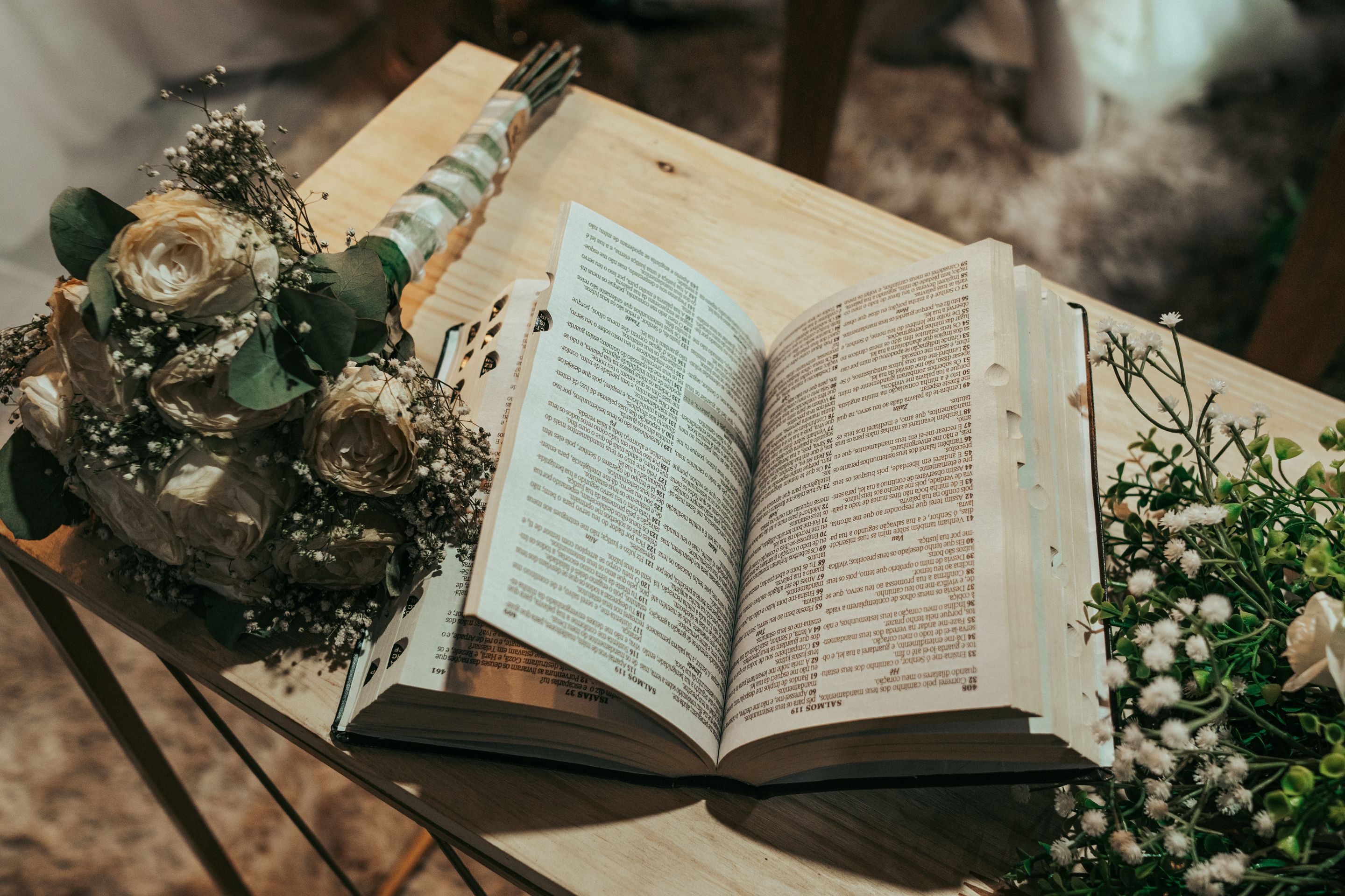 Bouquet of Roses Next to Opened Book on Desk · Free Stock Photo