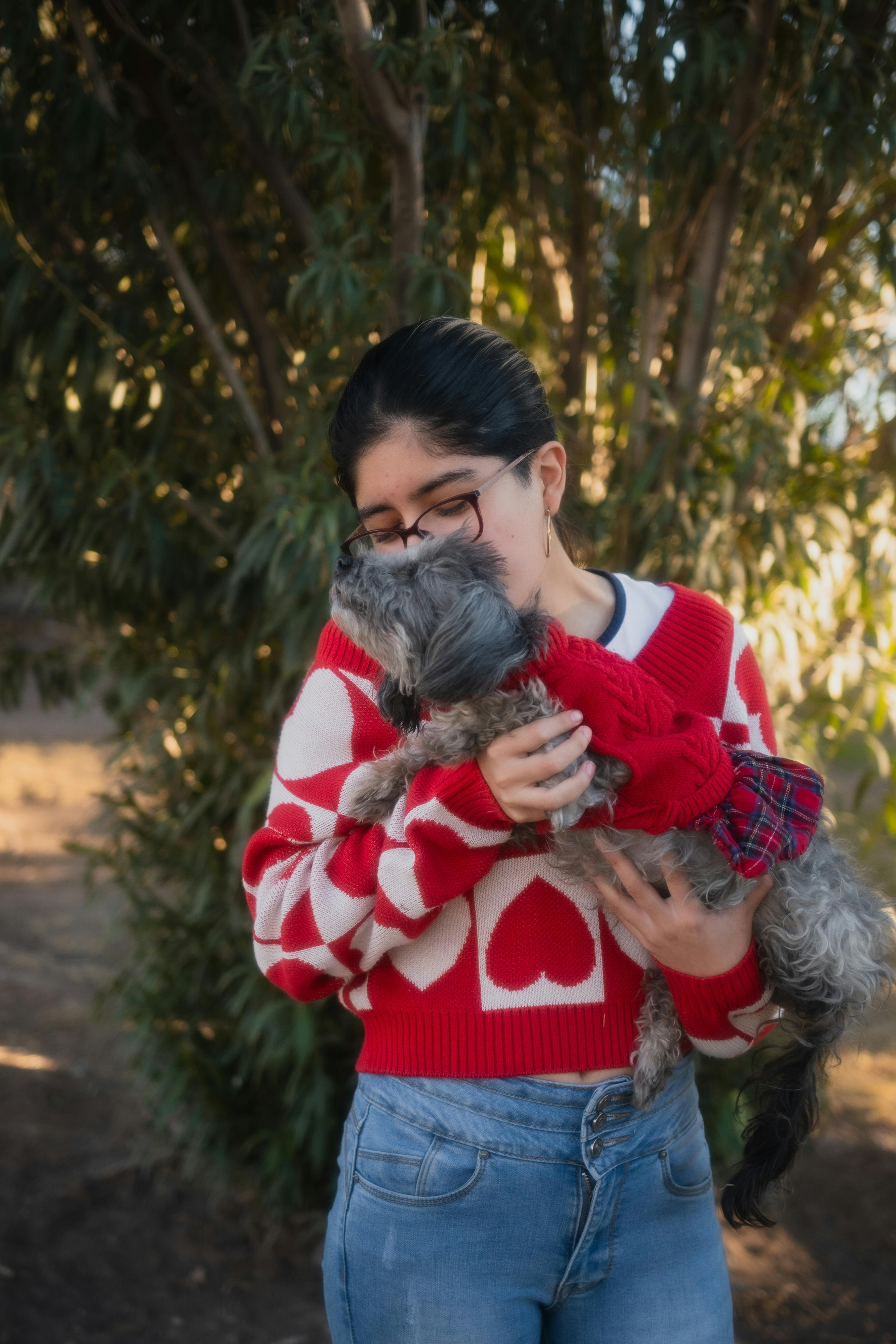 teenage girl holding small dog