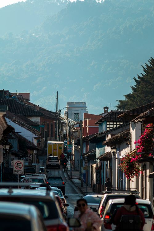 Free Scenic view of a bustling street in San Cristóbal de las Casas, Mexico, with mountains in the backdrop. Stock Photo