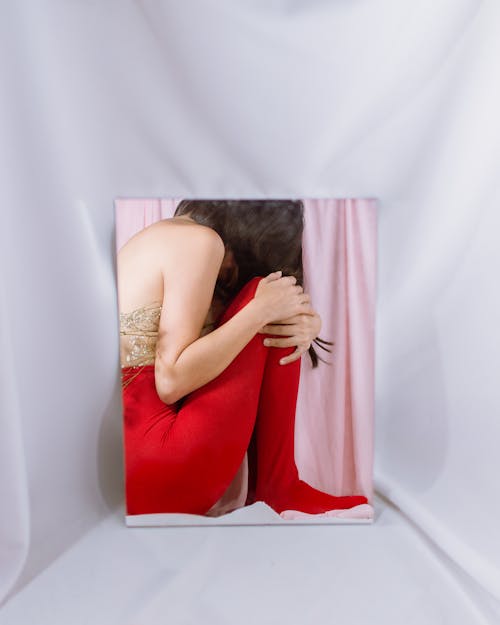 Woman in Red Dress Reflects in Mirror