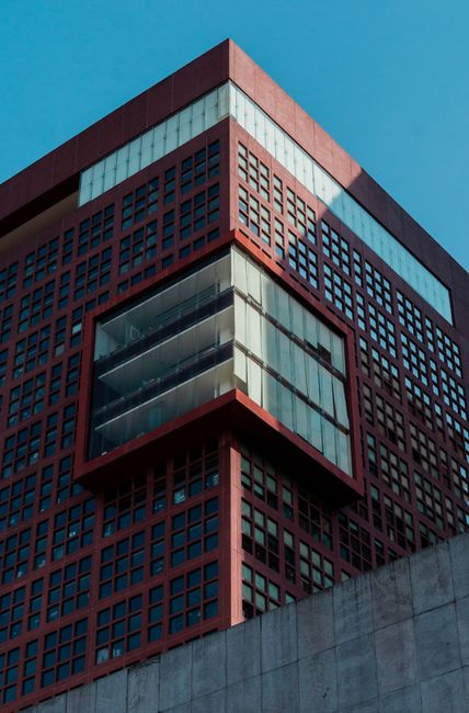 Abstract view of a geometric urban building against blue sky, highlighting modern architecture.