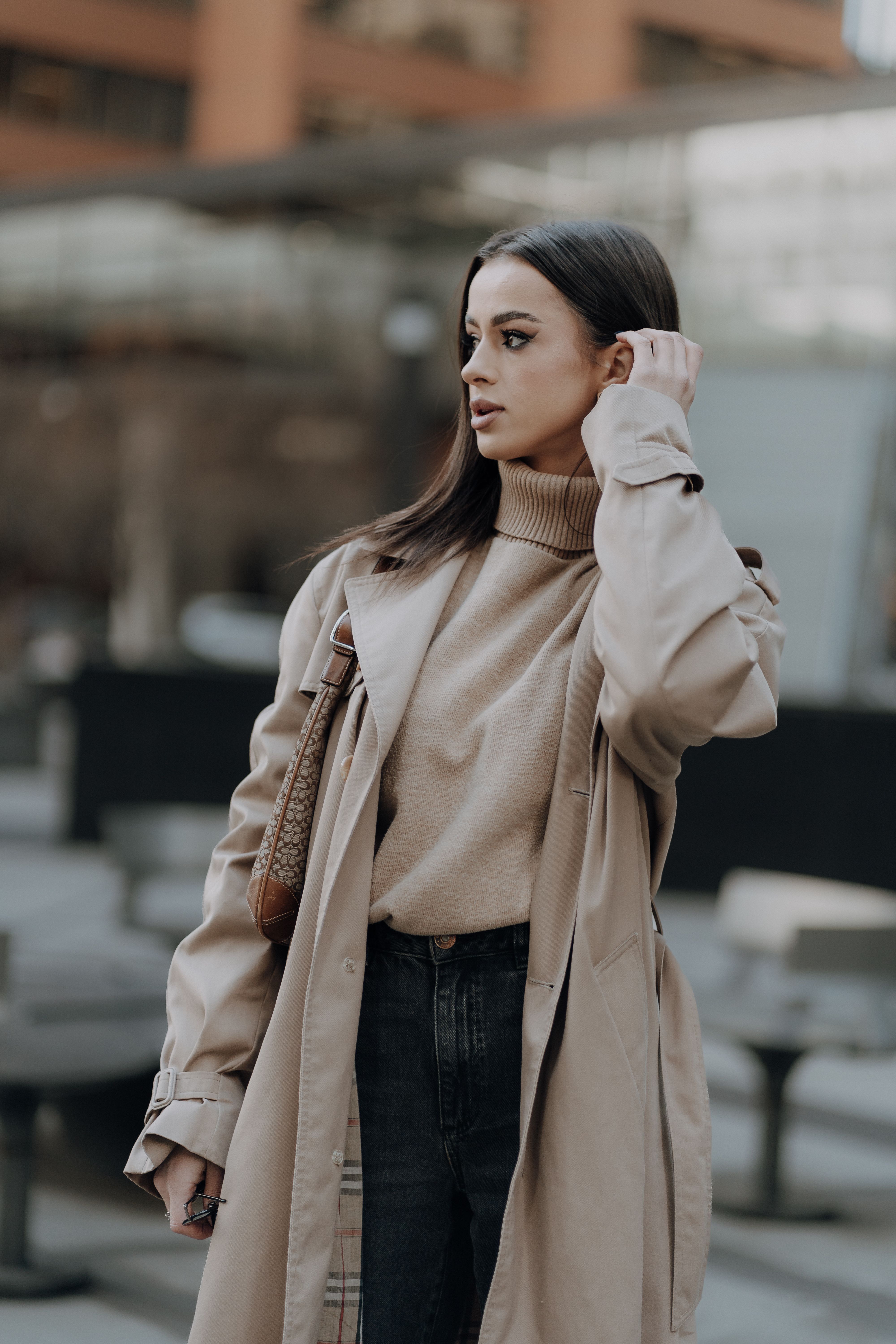 Camel wrap coat with cream turtleneck and straight-leg jeans