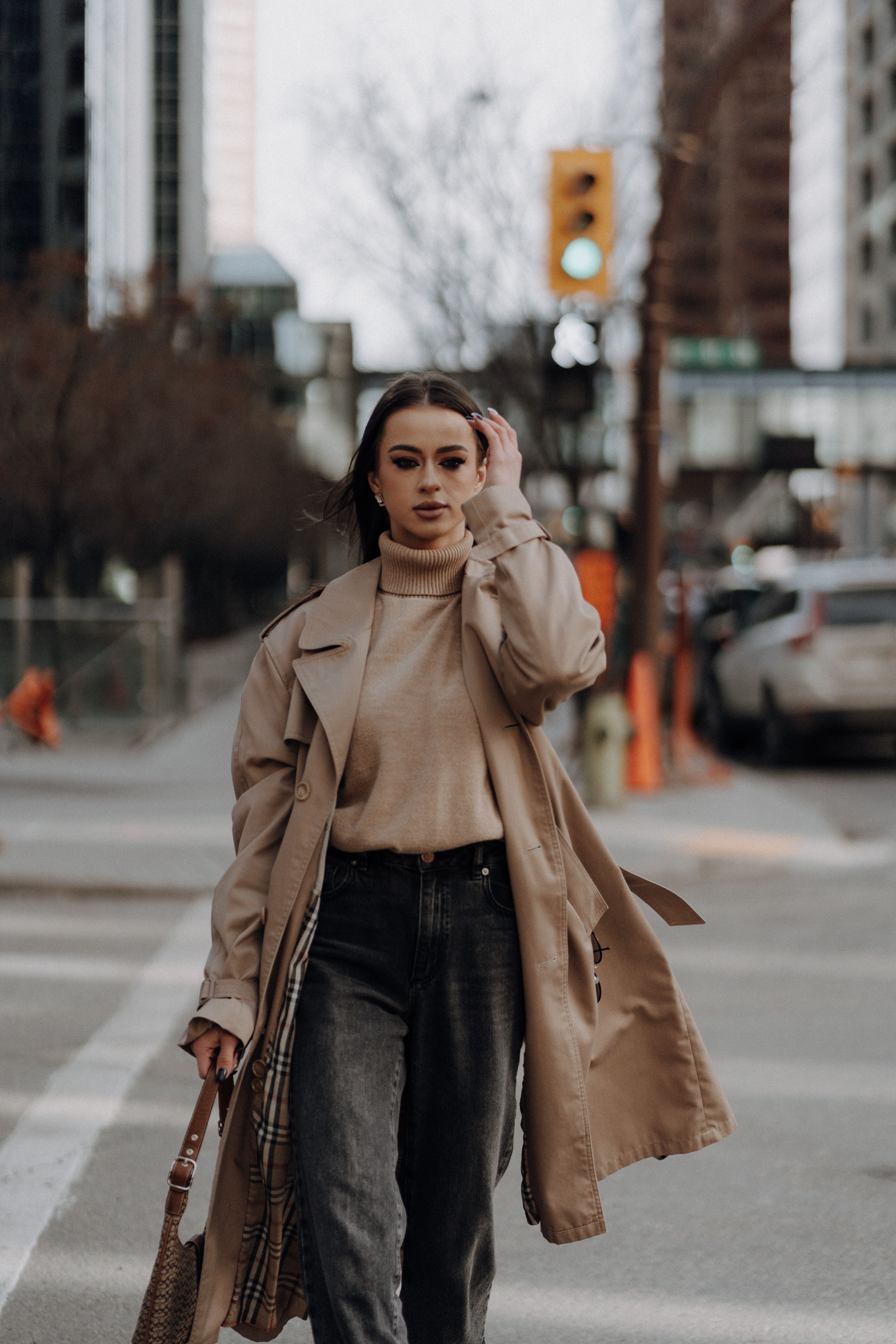 Woman in beige trench coat on the street