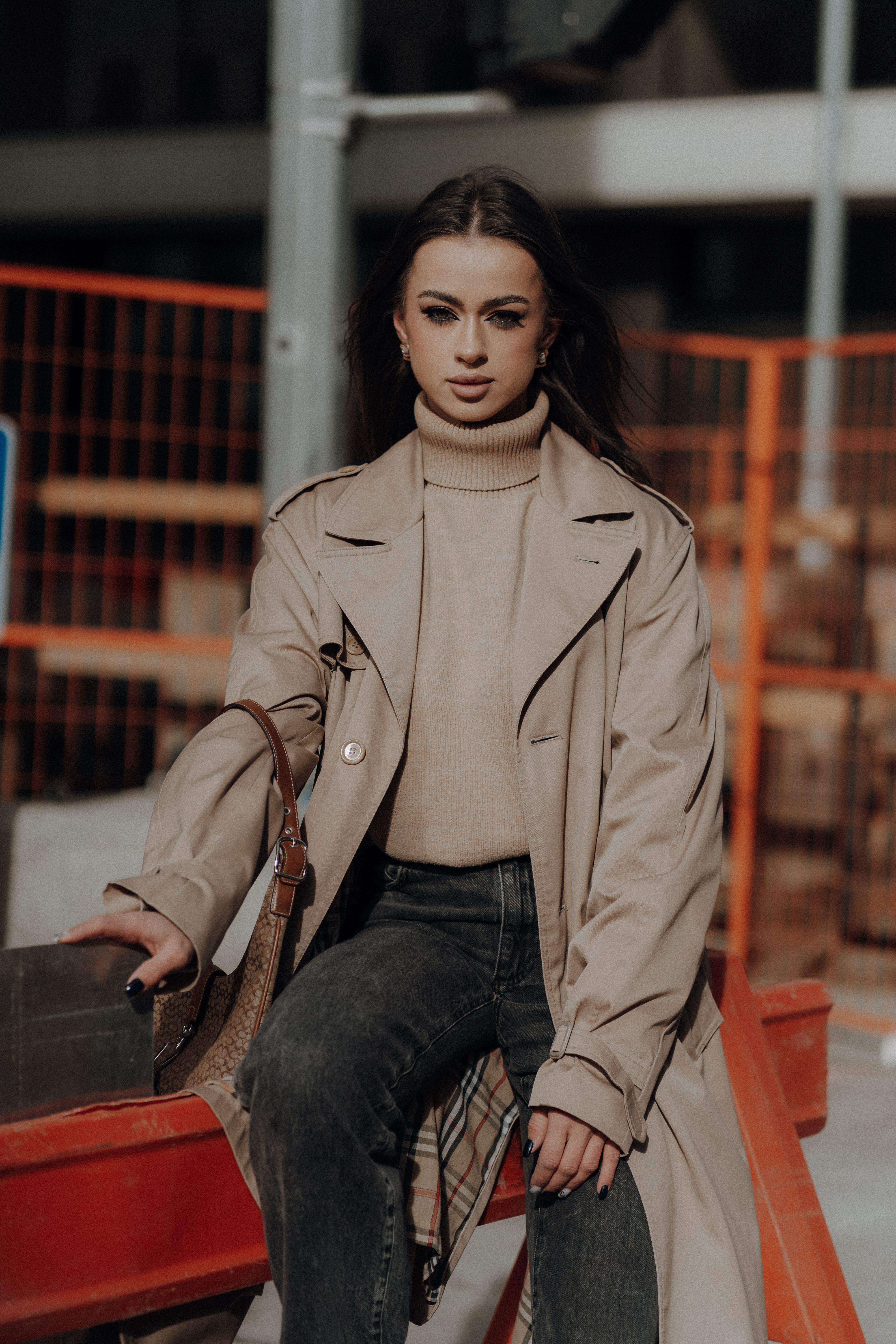 Woman Wearing Trench Coat on a Construction Field · Free Stock Photo