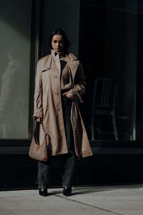 A woman in a trench coat and black pants