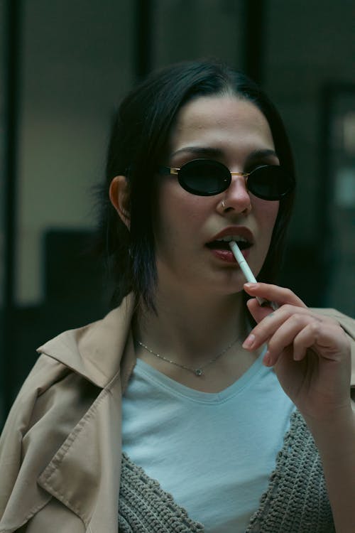 A woman with sunglasses and a cigarette