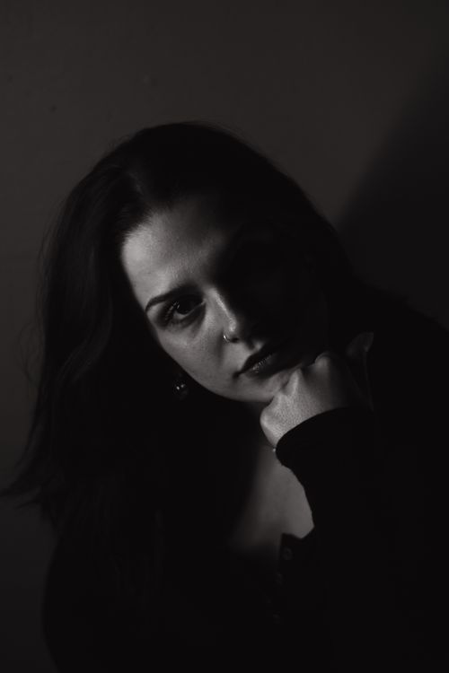Free Emotive black and white portrait of a woman in thoughtful pose. Stock Photo