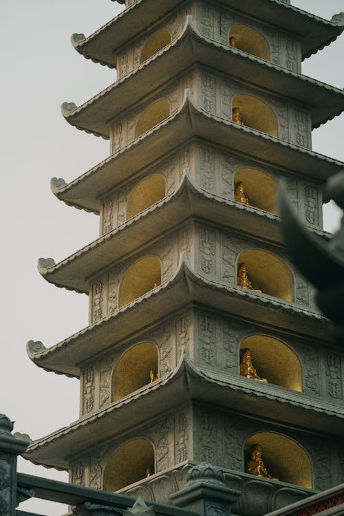 A tall pagoda with statues on it