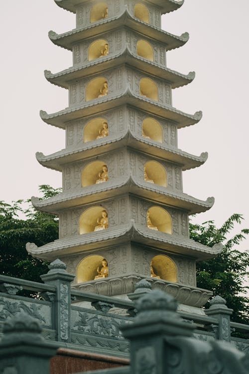 A pagoda with lights on it in the middle of the night