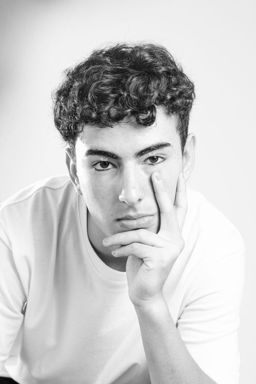 Free Striking black and white portrait of a young man with a thoughtful expression, suitable for diverse creative uses. Stock Photo