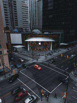 A striking aerial view of a busy intersection in downtown Vancouver featuring the iconic Apple Store.