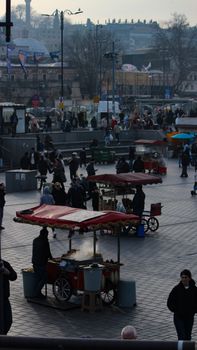 Vibrant street food scene in Istanbul with food stands and people walking around.