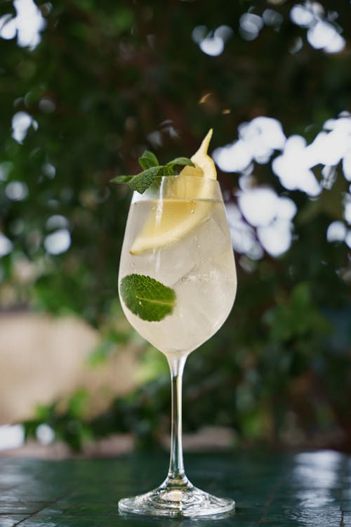 Close-up of a Cold Drink with Lemon and Mint in a Wineglass