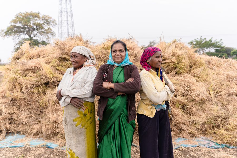 Three proud Indian women farmers standing in a field