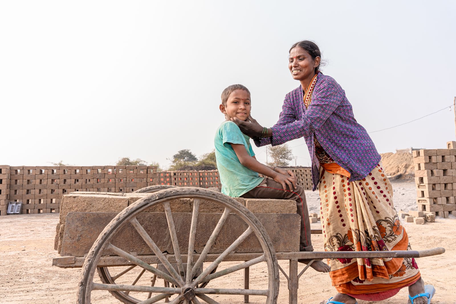 A mother holding her infant in rural India