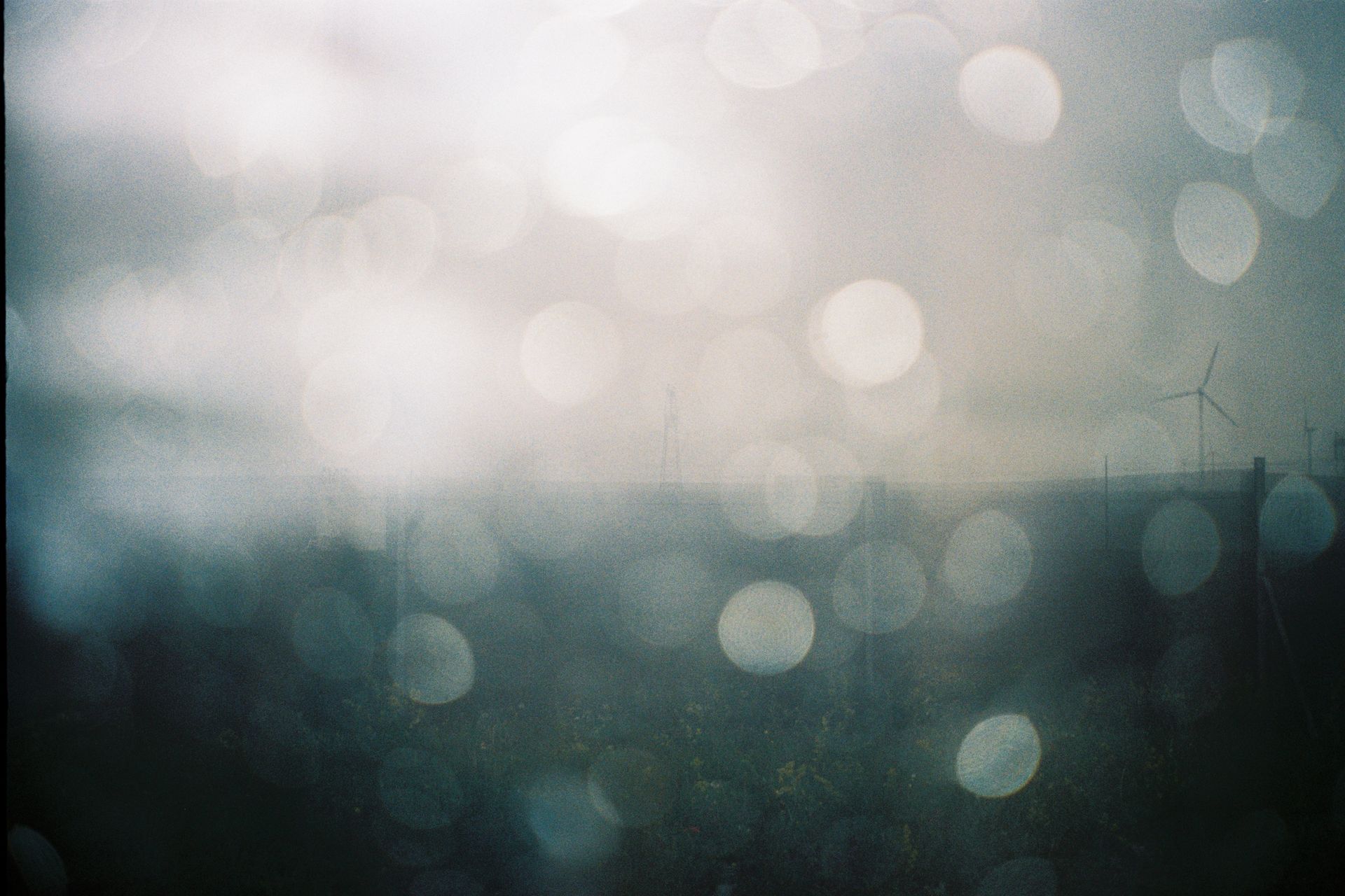 Misty landscape with wind turbines and bokeh effect in Inner Mongolia, China.