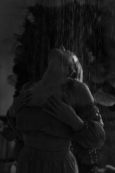 Artistic portrait of woman embracing rain in black and white.