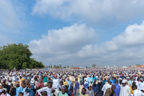 A large crowd of people gathered in a field