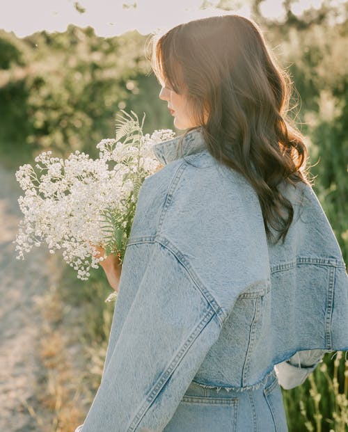 Brunette Woman Holding a Bouquet of White Flowers 