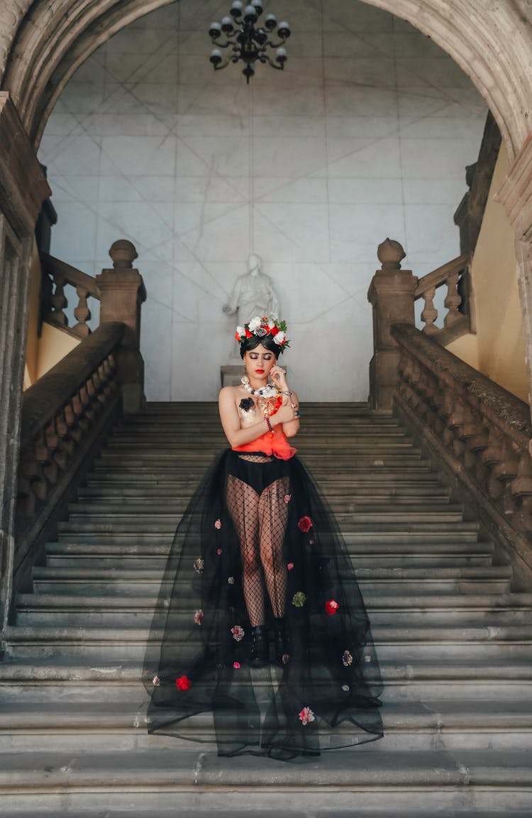 Model In Traditional Clothing Standing On Stairs