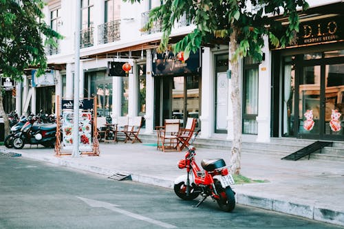 Red Motorcycle Parked Outside Storefront