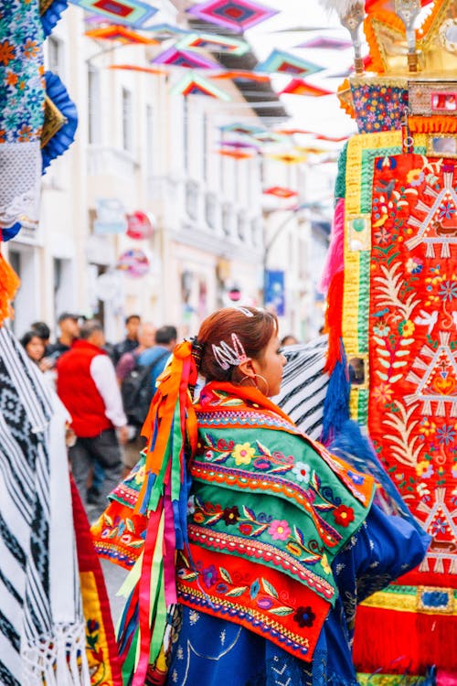 A woman in colorful clothing walking down a street