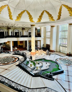 Luxurious hotel interior showcasing a grand staircase and elegant design elements.