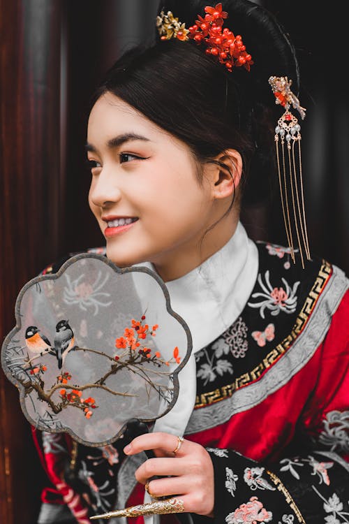 Smiling Woman in Traditional Clothing and with Fan