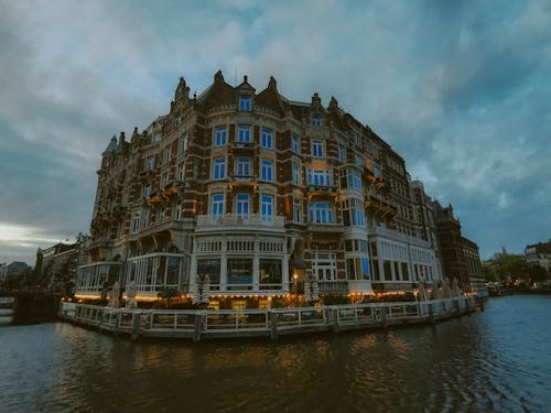 A building on the water with a cloudy sky
