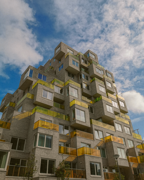 A modern cubic apartment building showcasing unique architectural design against a blue sky.