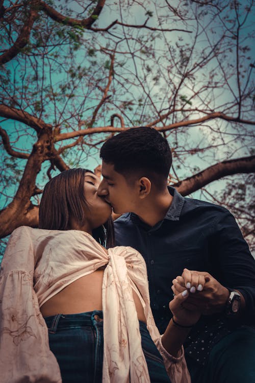 Free Couple Holding Hands and Kissing Stock Photo