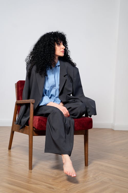 Woman with Curly Hair Sitting on Chair