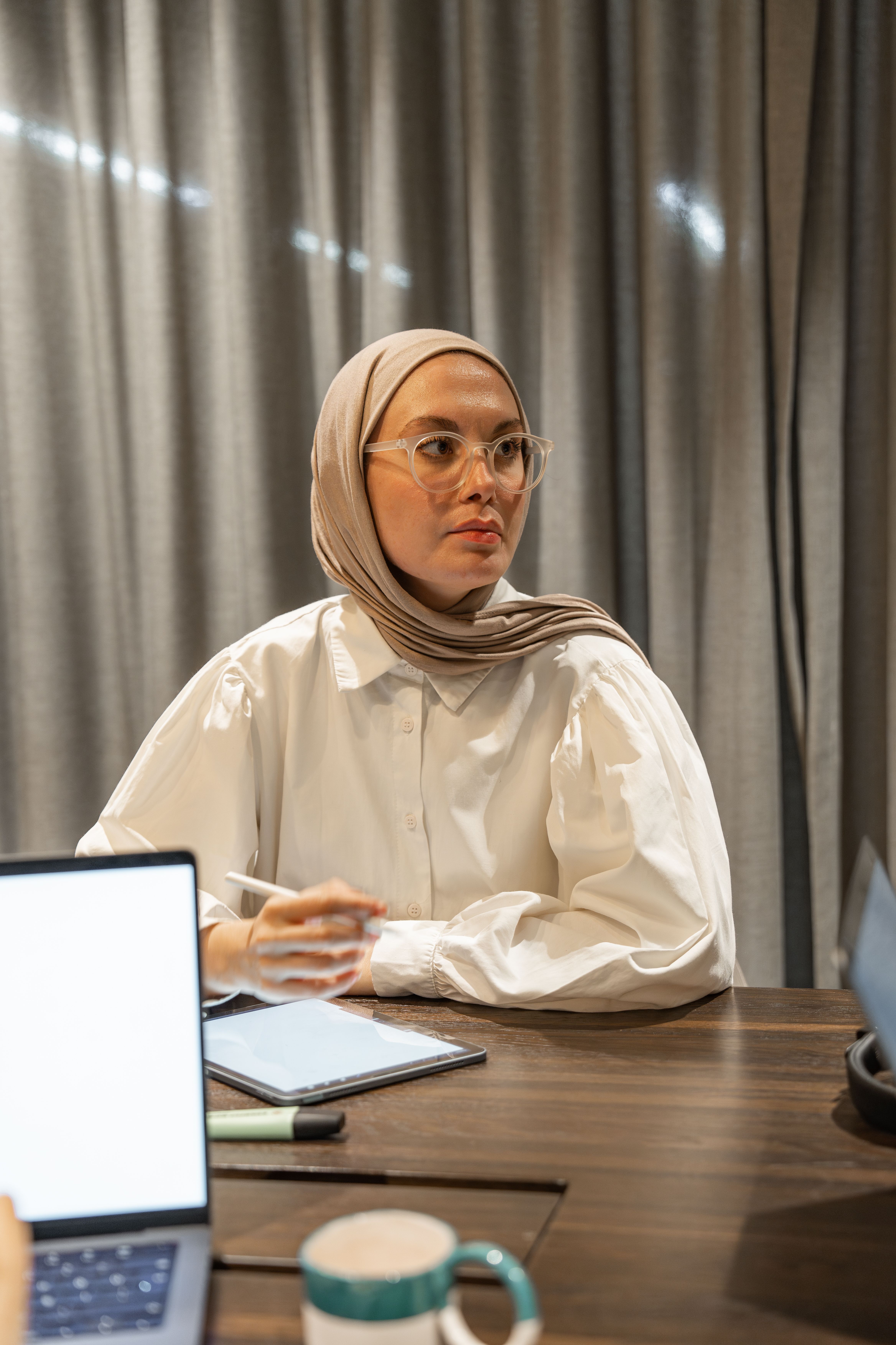 Woman in Hijab and White Shirt Sitting by Table · Free Stock Photo
