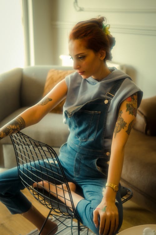 Woman in Jean Overalls and with Tattoos